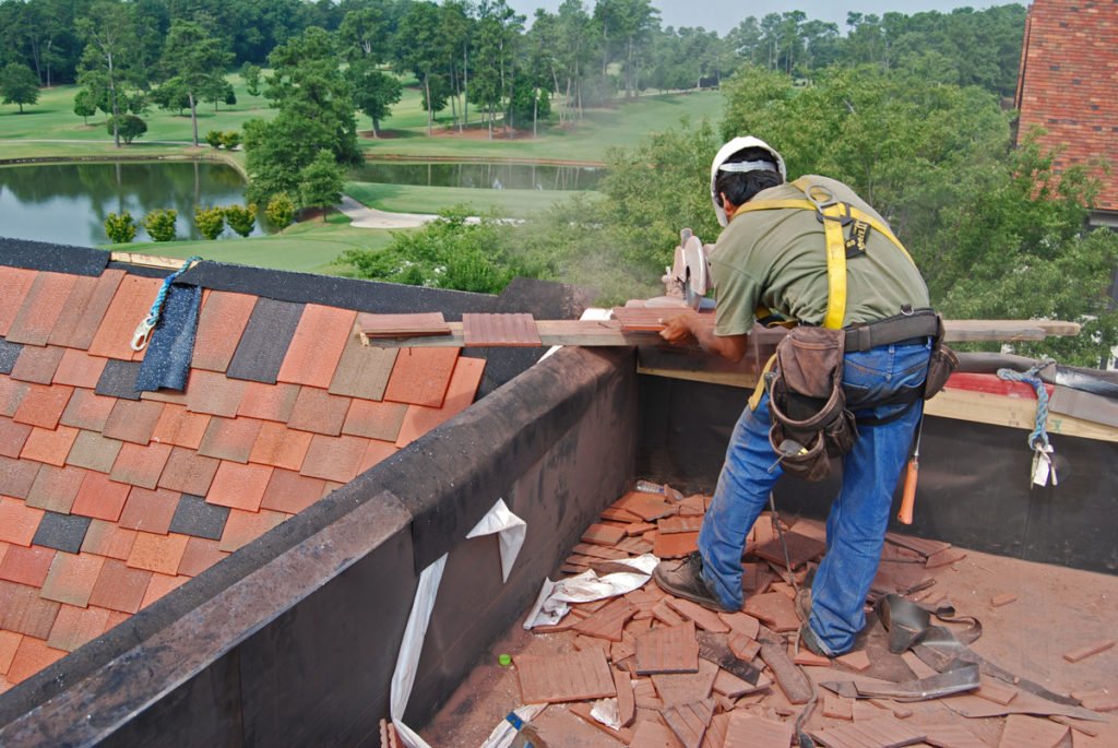 roofer replacing tiles
